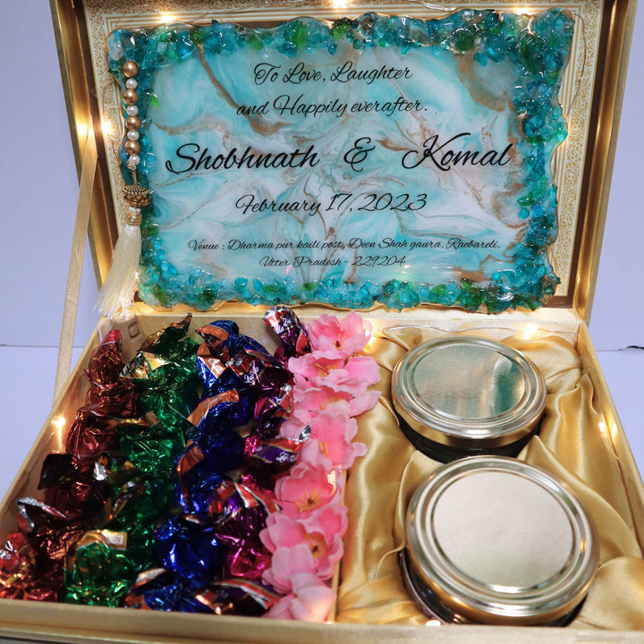 Buy / order premium resin invitation frame combo online in India. And get delivered pan India near me. Order all resin and acrylic handmade art pieces from https://www.thewalloffaith.com/ the official website of wall of faith. It is used to send invitation of marriage to bride side or groom side. Most luxurious resin invitation frame combo is our one of the bestseller product. It comes with royal resin invitation frame, chocolates, jelly, dryfruits,light,box,decorations.