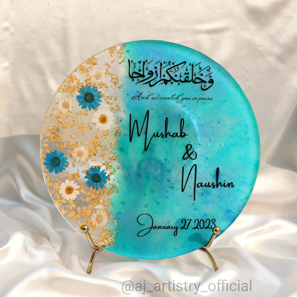 Buy / order Circle shaped resin nikah frame with white real dried flowersonline in India. And get delivered pan India near me. Order all resin and acrylic handmade art pieces from https://www.thewalloffaith.com/ the official website of wall of faith. Can be kept as table decor. Can be used for marriage gift, nikah gift, engagement gift, couple gift, anniversary gift.